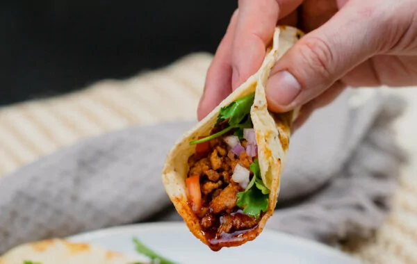 Mini tacos of chipotle brisket, red onion and radish.