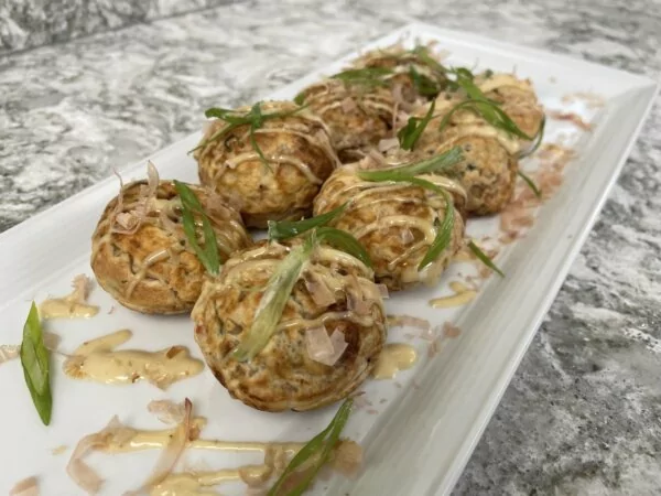 A platter of takoyaki, a traditional Japanese street food made with octopus.