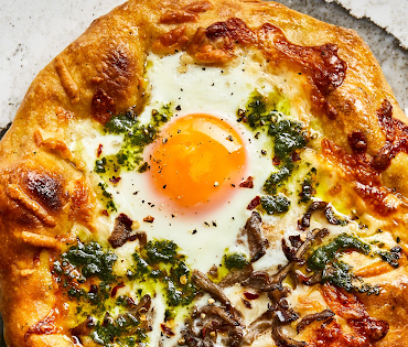 Breakfast pizza with pesto, egg and cheese