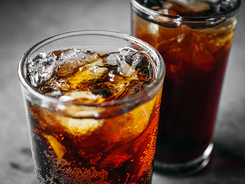 Glasses of iced cola with visible carbonation, illustrating consumer preference for traditional soft drink flavors over experimental options.