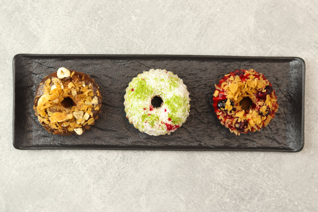 Strings of dried vegetables and peppers hanging beneath jars of grains and legumes, emphasizing sustainable flavor development and traditional preservation methods.