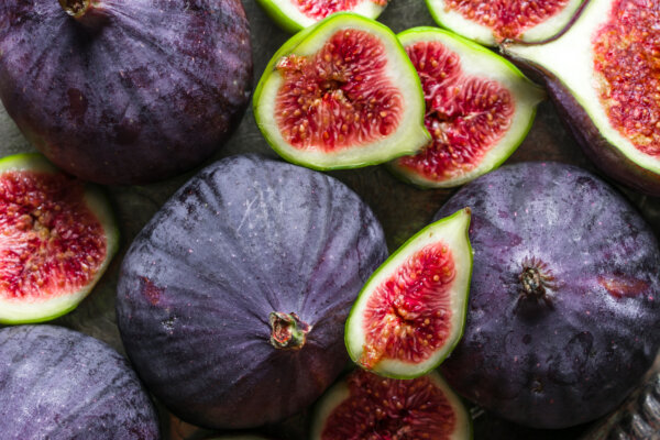 Close-up of while and sliced figs showing rich, juicy interiors and contrasting textures enhances the sensory experience of food.