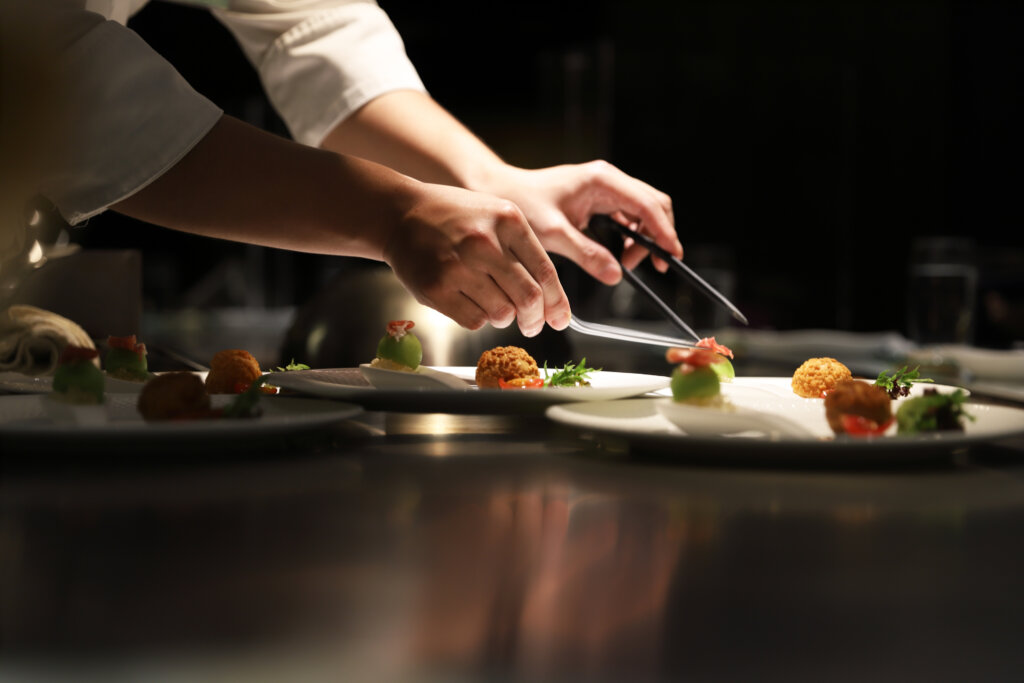 Chef carefully plating food to highlight food texture as a key indicator of food quality 