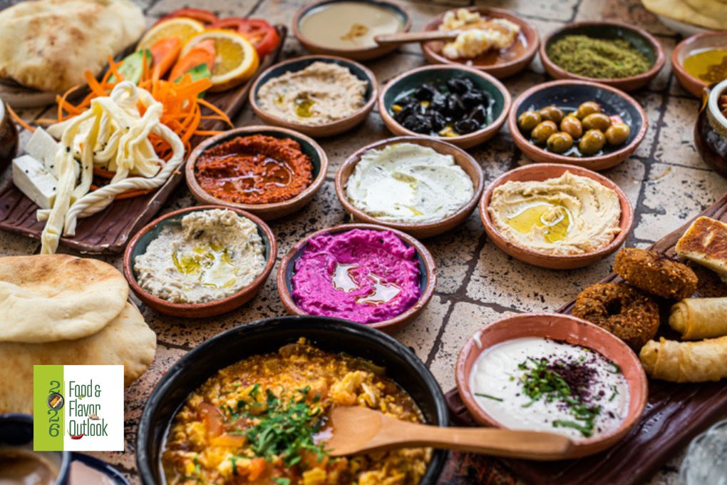 Assortment of colorful dips, spreads, and appetizers, representing bold, layered flavors across familiar formats.