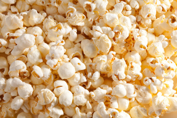 Close-up of fluffy popcorn representing a mango-habanero flavor concept that combines sweet tropical fruit notes with spicy pepper heat.