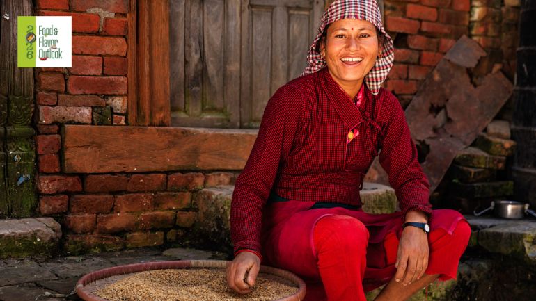 Woman preparing grains from the agriculture society using traditional food practices, highlighting the connection between cultural traditions and nutrient-dense eating.