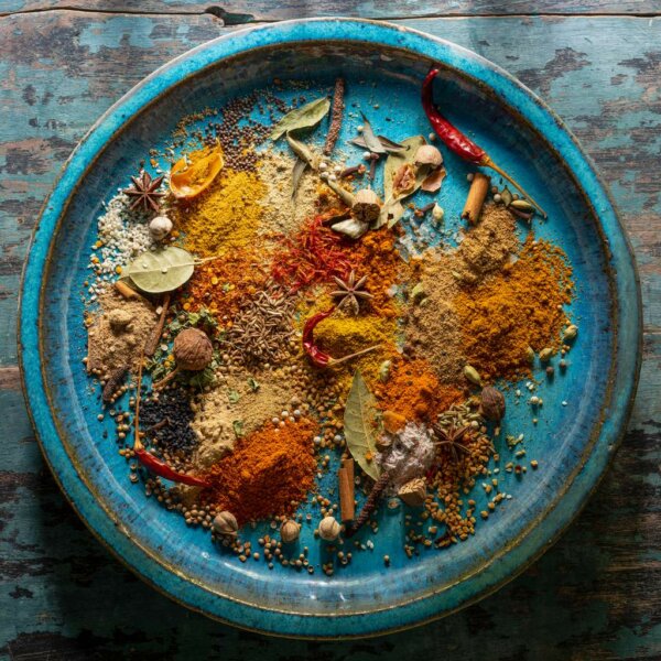 Blue tray, filled with different type of spices.