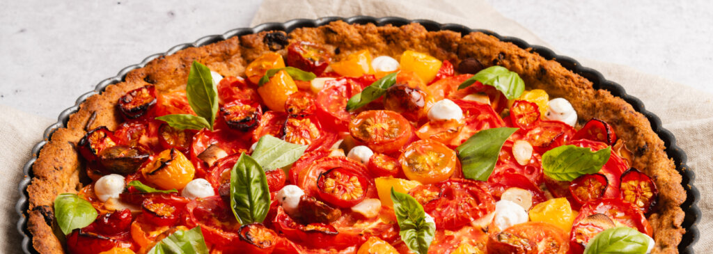 A savory tart with tomatoes, mozzarella, and basil.