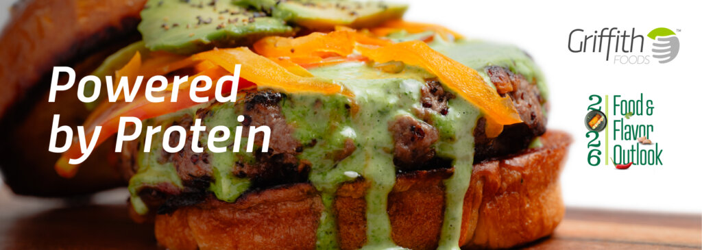 Powered by Protein. Griffith Foods 2026 Food and Flavor Outlook. A high protein burger blended sweet potato, red quinoa and grass-fed beef patty was served on warm flatbread with tomato-date ketchup, moringa aioli, and garlic pickles.
